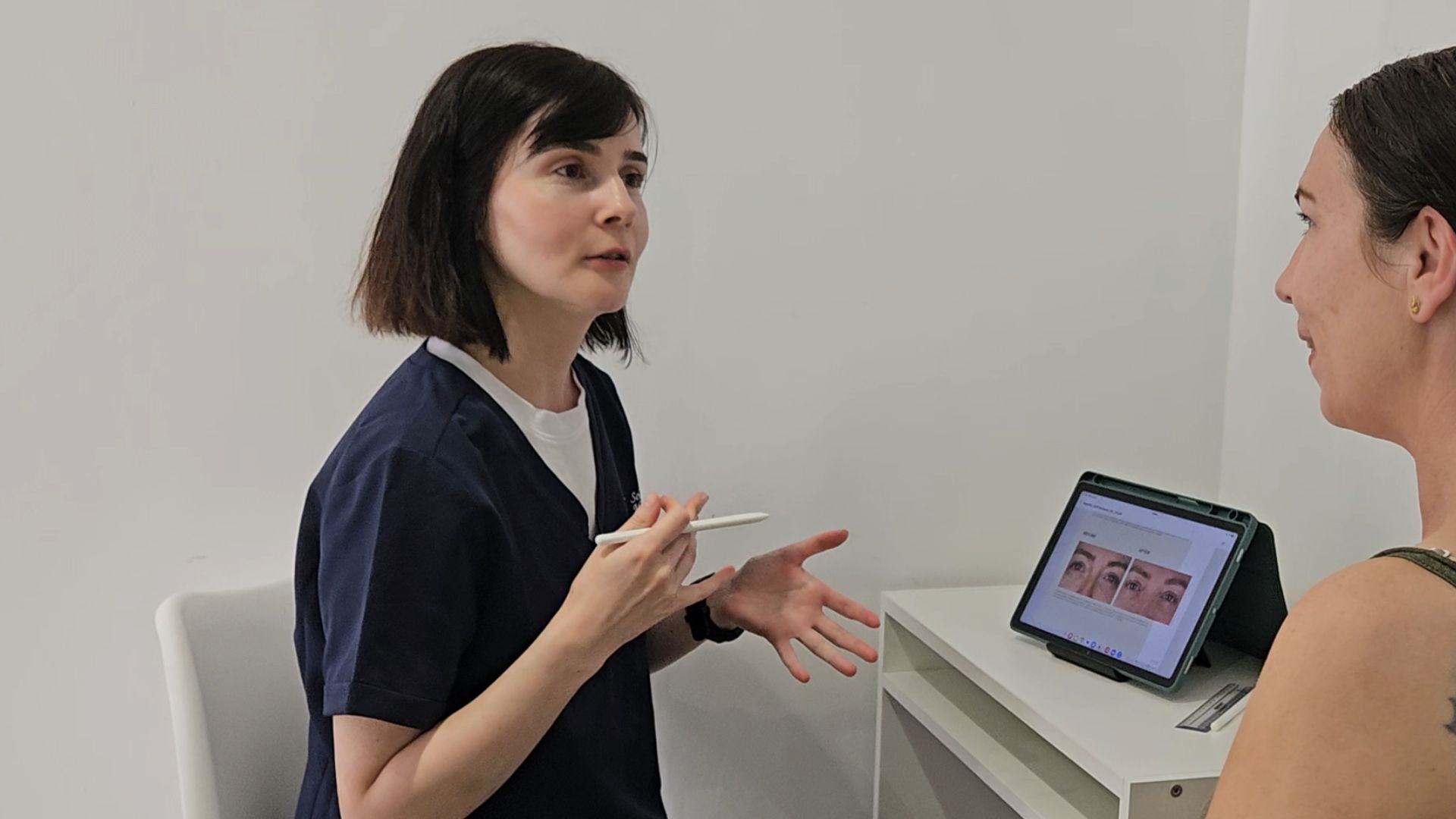 Aesthetic Practitioner Alexandra Mitrea during a consultation with a client, explaining the treatment and the outcomes.
